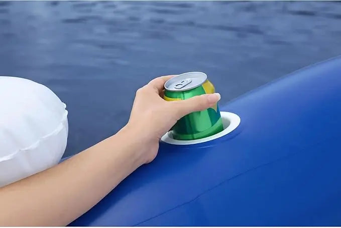 Hand placing a green can on a blue surface with water in the background
