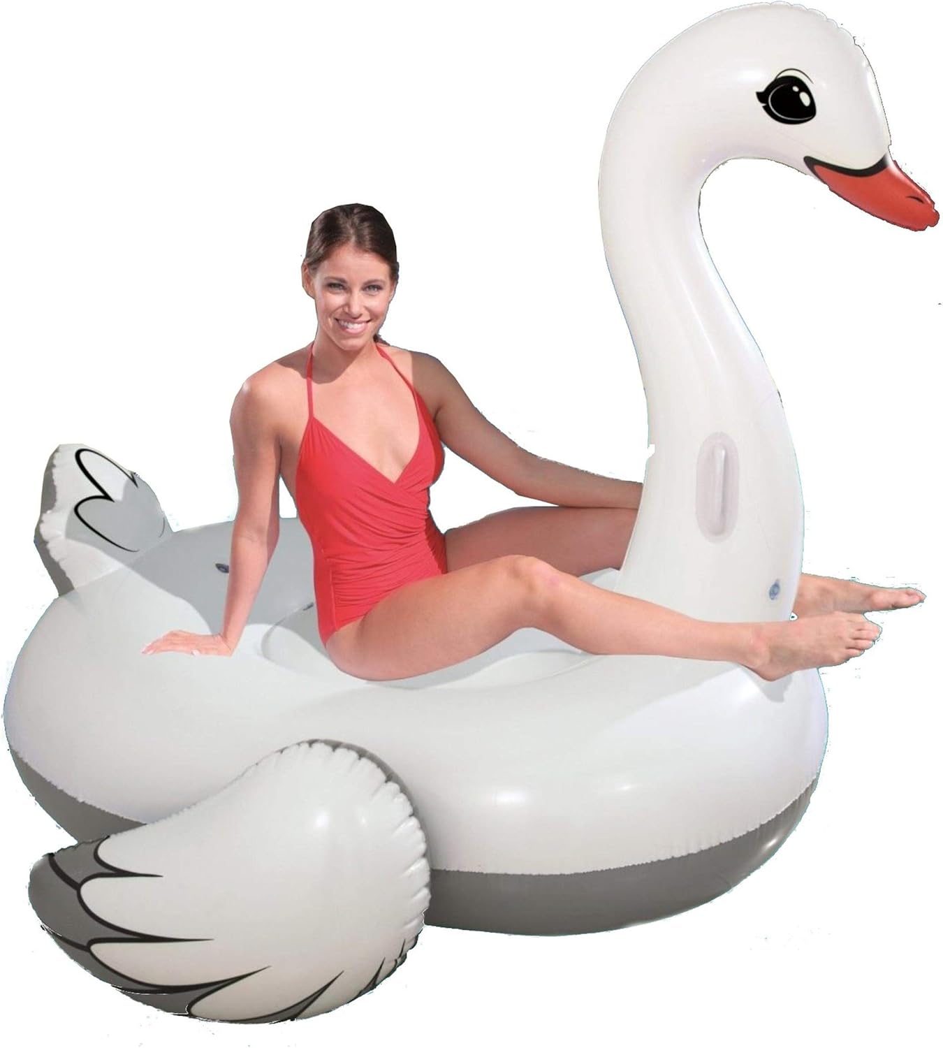 Woman in a red swimsuit sitting on an inflatable swan pool float against a white background