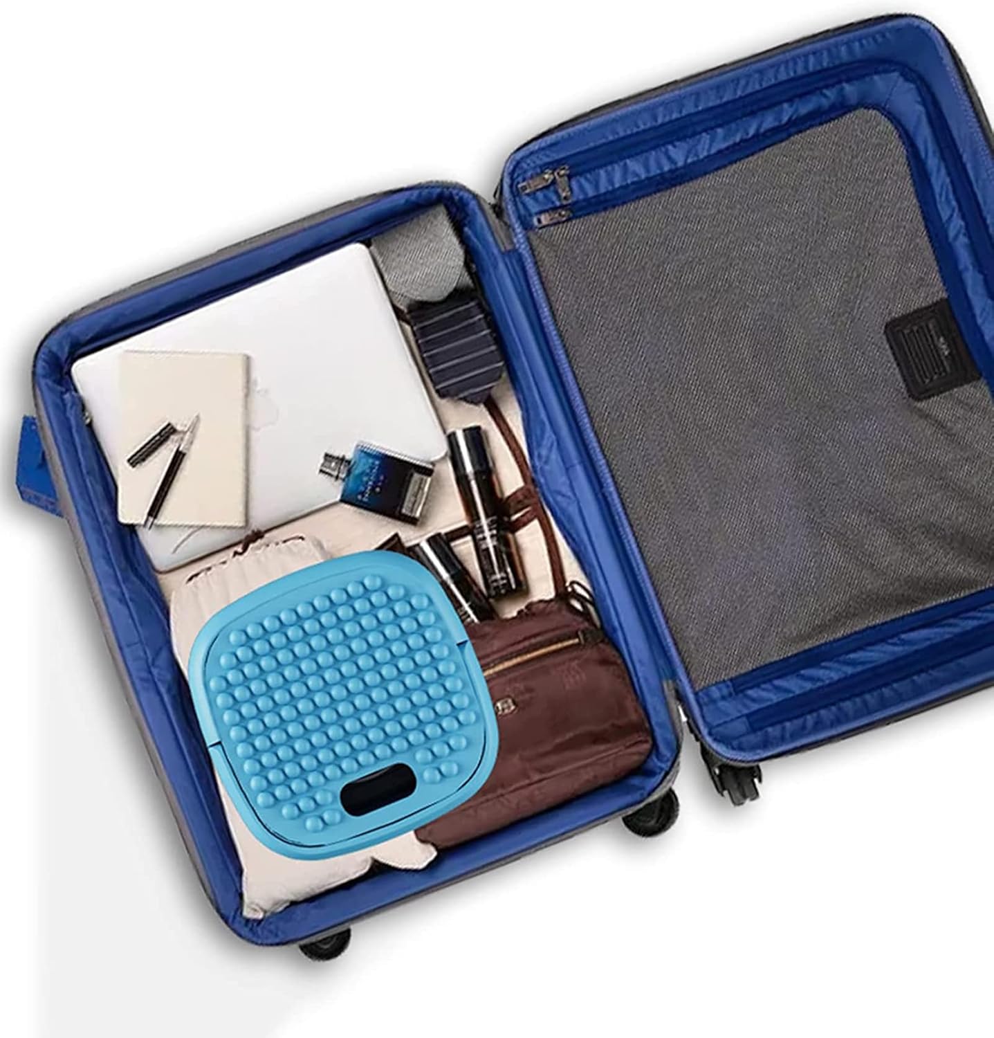 Open blue suitcase with various items including a blue cushion and a brown bag.