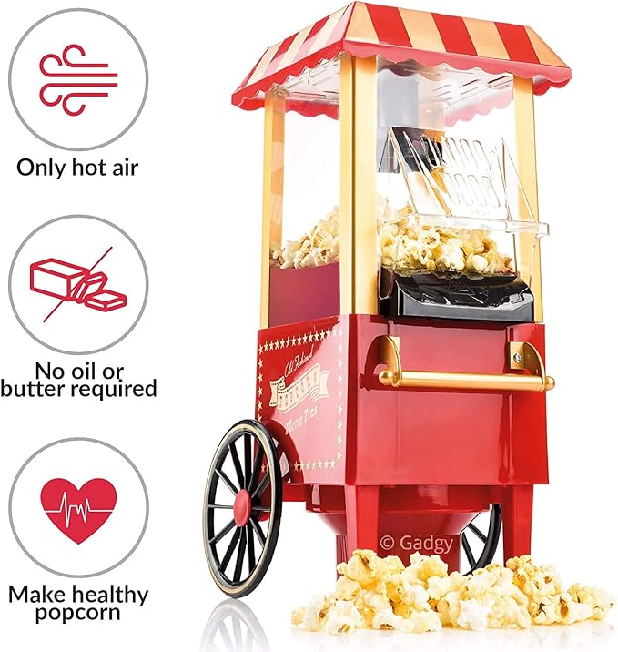 Red and gold popcorn machine with popped popcorn on a white background, featuring icons and text about cooking method.