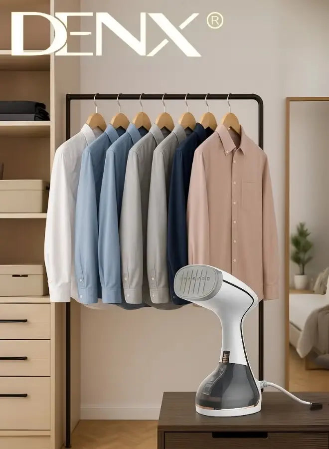 DENX steamer on a table with shirts hanging on a rack in the background