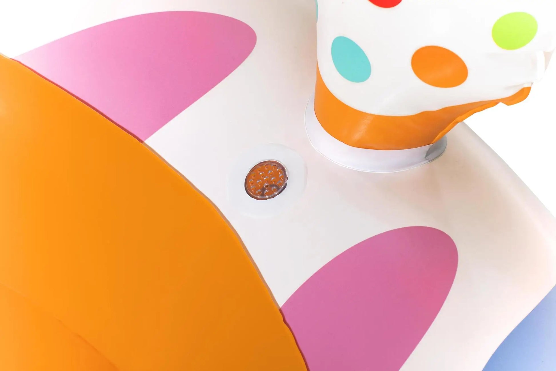 Colorful polka dot cupcake on a white plate with a polka dot background