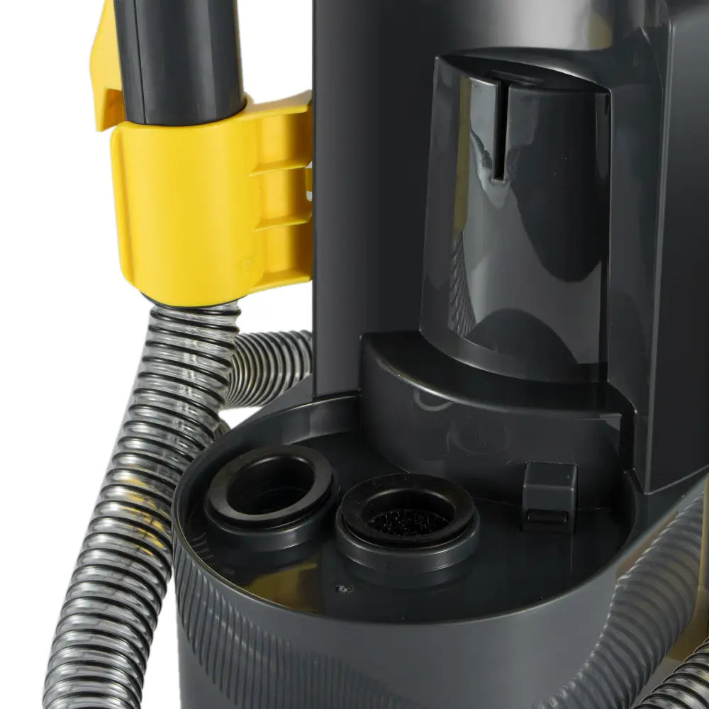 Close-up of a black and yellow vacuum cleaner with a hose attachment on a white background