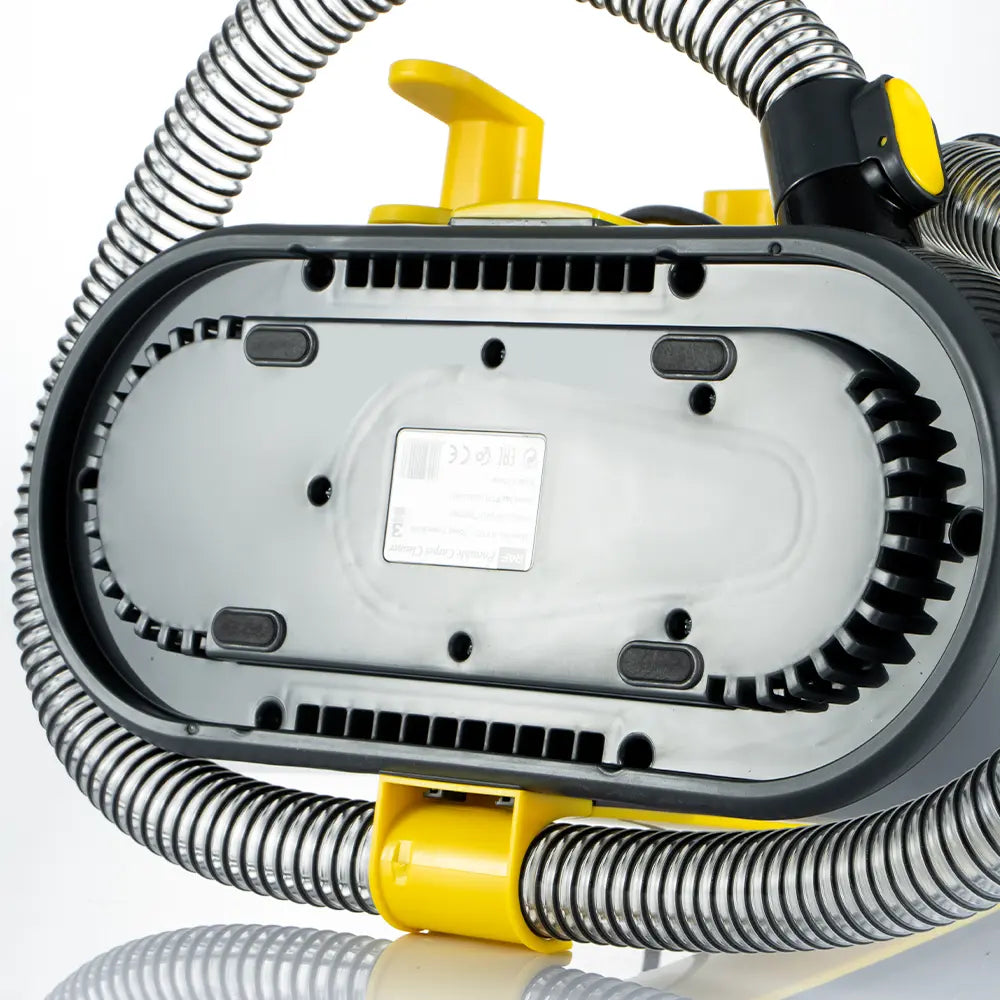 Close-up of a vacuum cleaner with visible gears and hoses on a white background