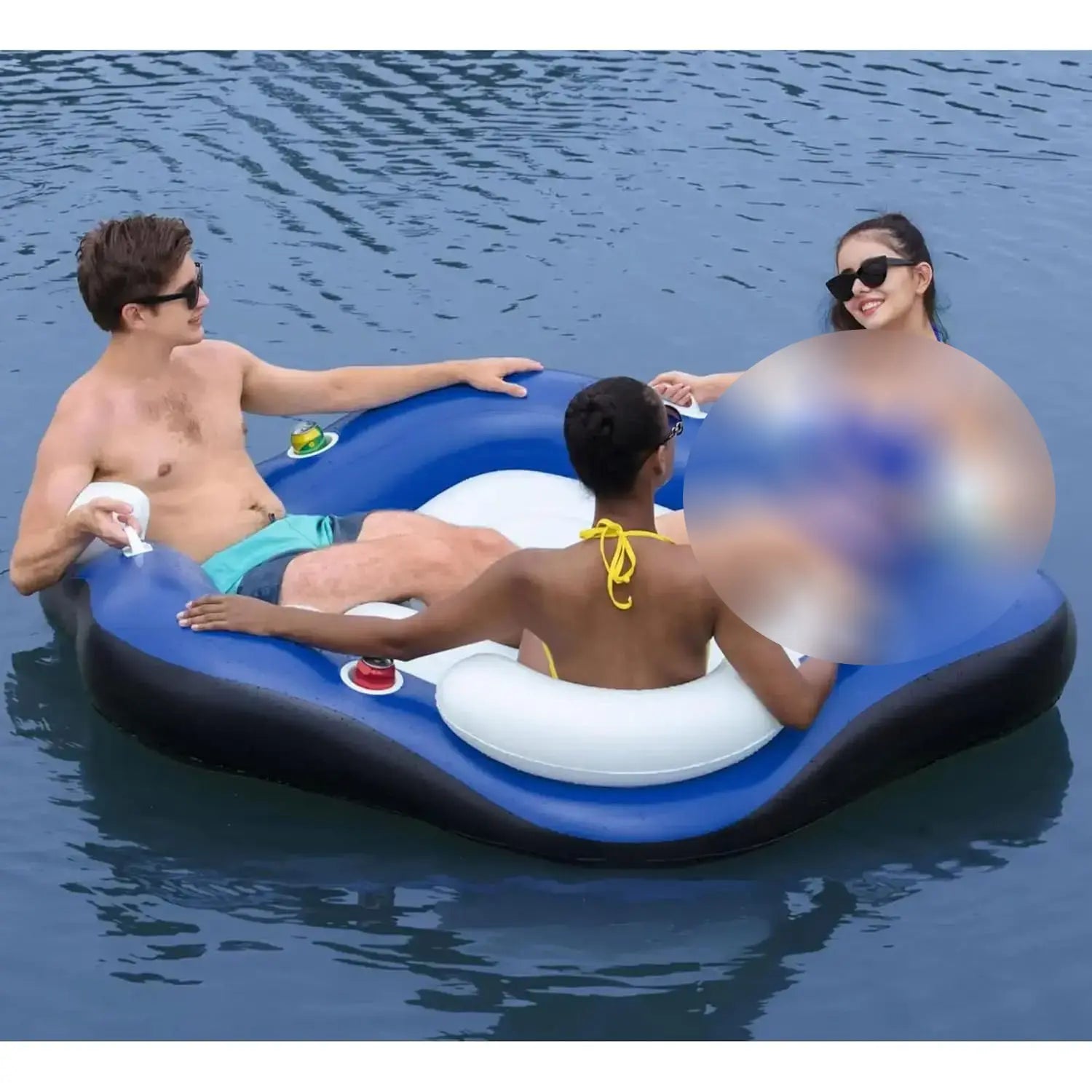 Three people on a blue inflatable raft in the water